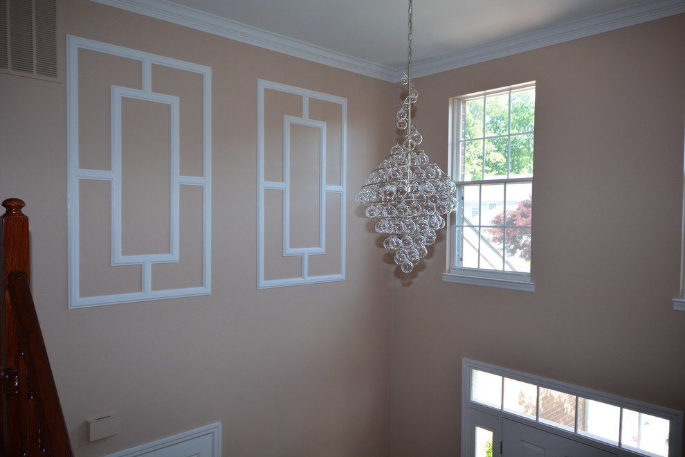Inspiration for a large transitional dark wood floor foyer remodel in Baltimore with orange walls and a white front door