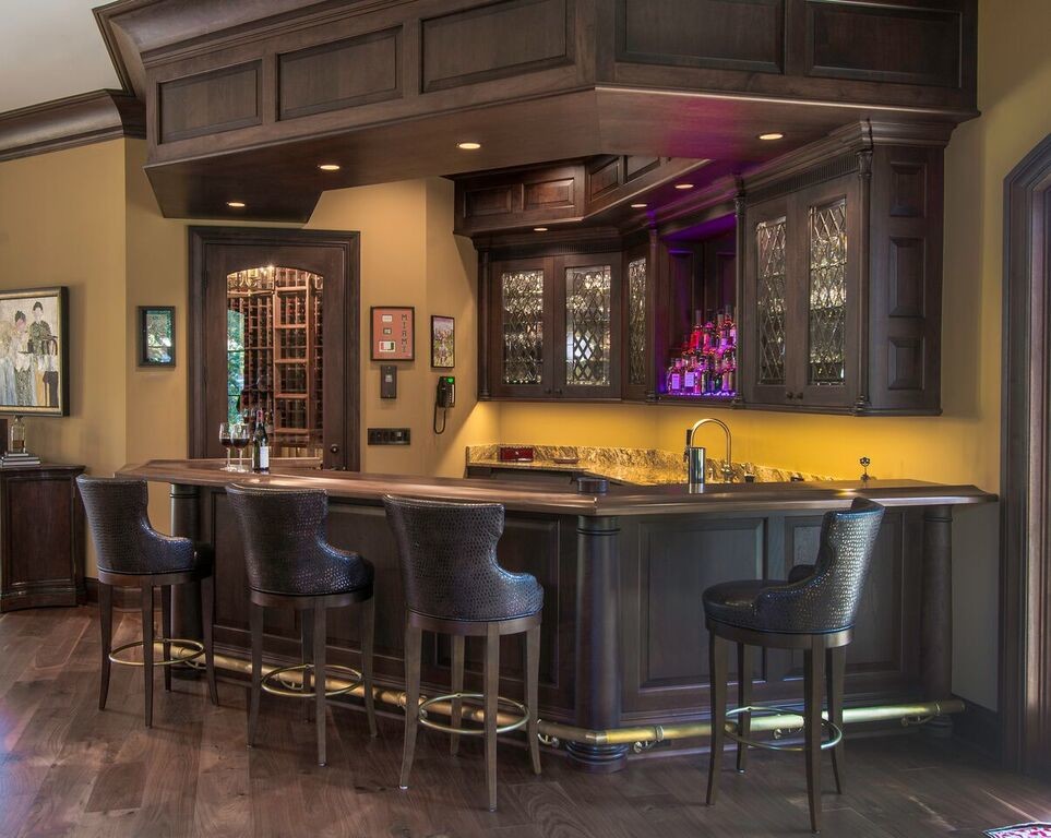 Design ideas for a large contemporary wet bar in Tampa with an undermount sink, raised-panel cabinets, dark wood cabinets, marble benchtops, beige splashback and dark hardwood floors.