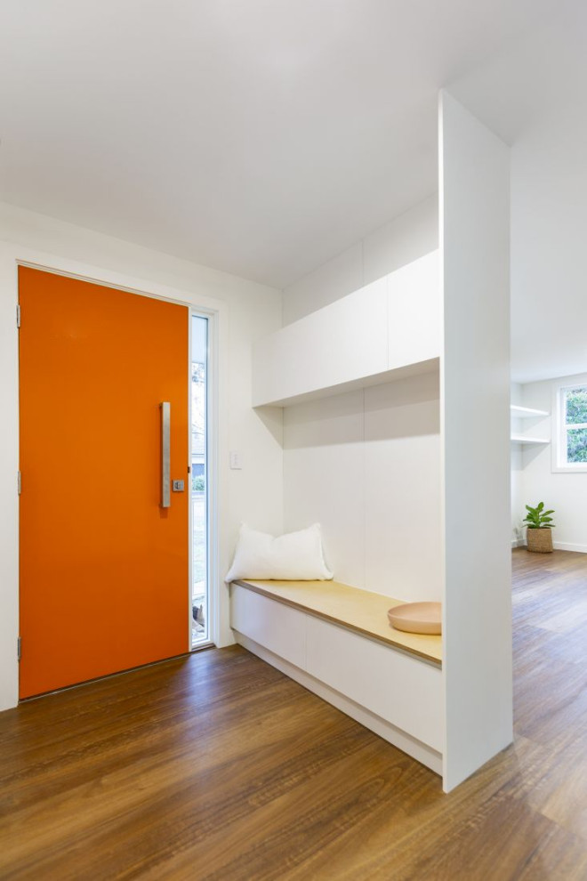 Inspiration for a small contemporary laminate floor and brown floor entryway remodel in Canberra - Queanbeyan with white walls and an orange front door