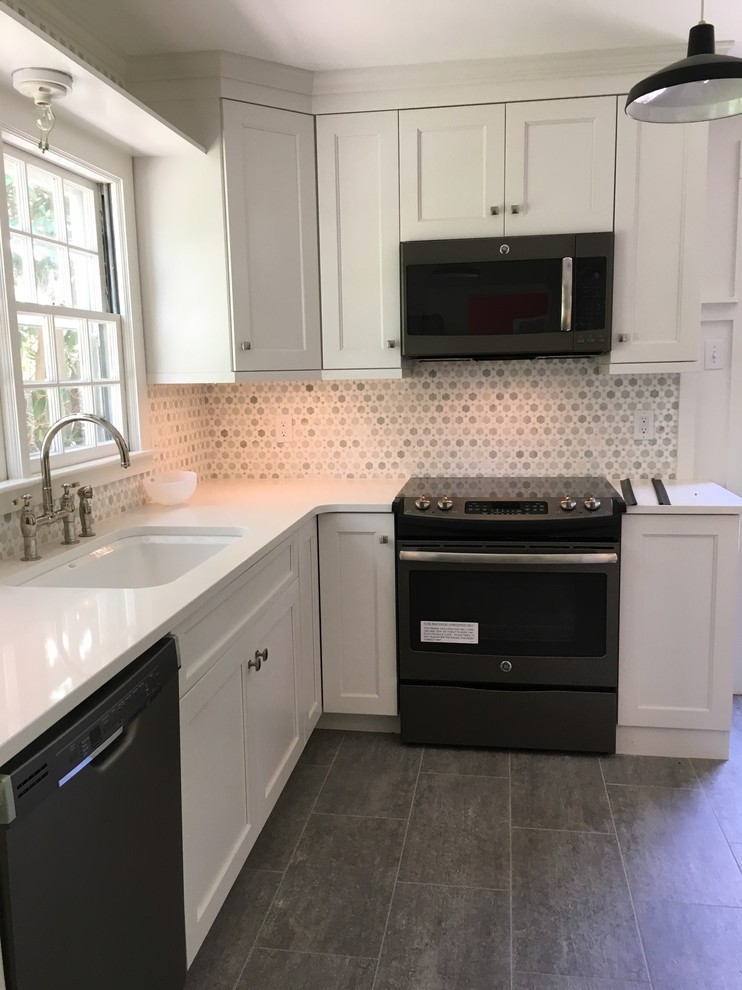 Design ideas for a mid-sized transitional l-shaped eat-in kitchen in Boston with an undermount sink, shaker cabinets, white cabinets, quartz benchtops, grey splashback, mosaic tile splashback, stainless steel appliances, limestone floors and no island.