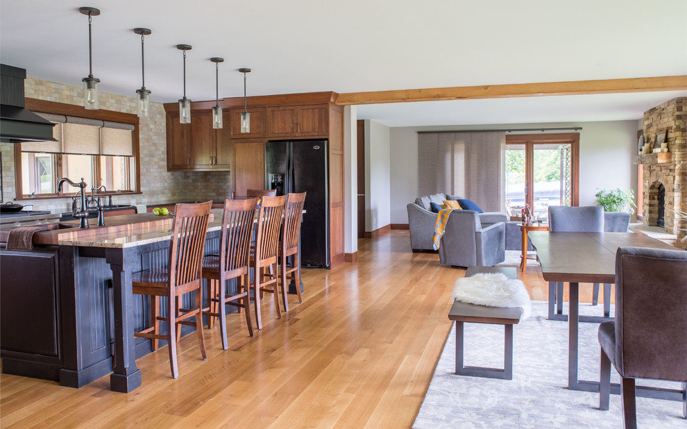 Inspiration for a mid-sized rustic galley light wood floor and beige floor open concept kitchen remodel in Cedar Rapids with recessed-panel cabinets, medium tone wood cabinets, granite countertops, beige backsplash, black appliances, an island, subway tile backsplash and multicolored countertops