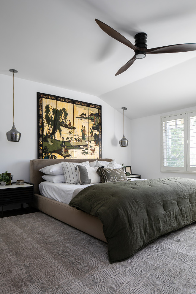 На фото: хозяйская спальня среднего размера в современном стиле с белыми стенами, полом из винила, стандартным камином, фасадом камина из плитки и коричневым полом