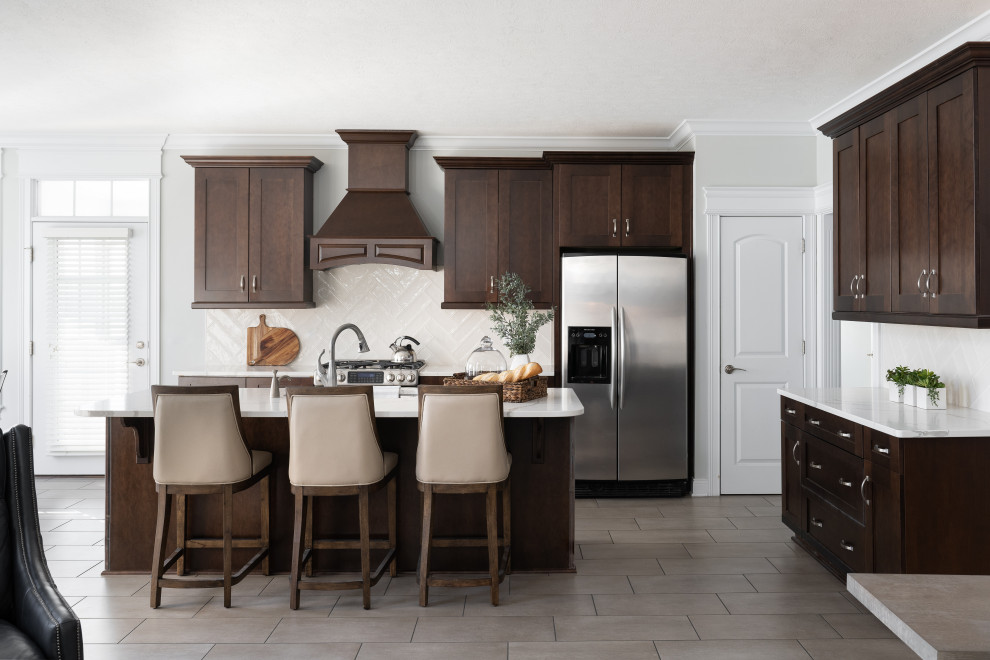 Inspiration for a mid-sized modern l-shaped separate kitchen in Indianapolis with an undermount sink, shaker cabinets, brown cabinets, marble benchtops, subway tile splashback, stainless steel appliances, with island and white benchtop.