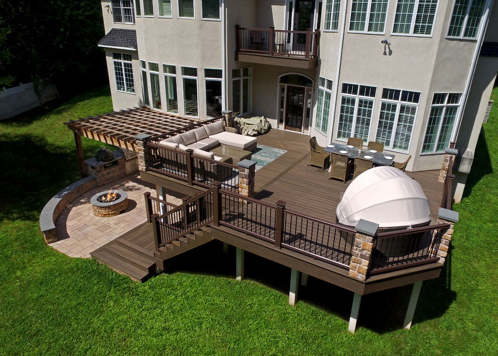 Example of a transitional backyard outdoor kitchen deck design