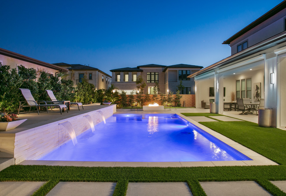 Large transitional backyard rectangular pool in San Diego with with a pool and tile.