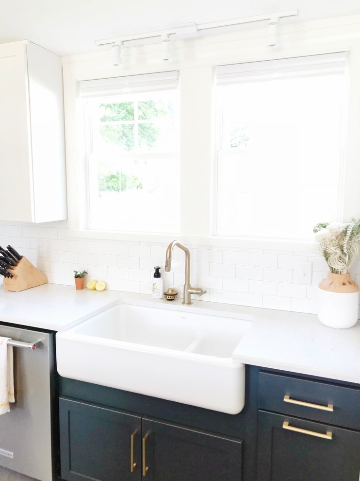 Kitchen - transitional gray floor kitchen idea with a farmhouse sink, quartz countertops and stainless steel appliances
