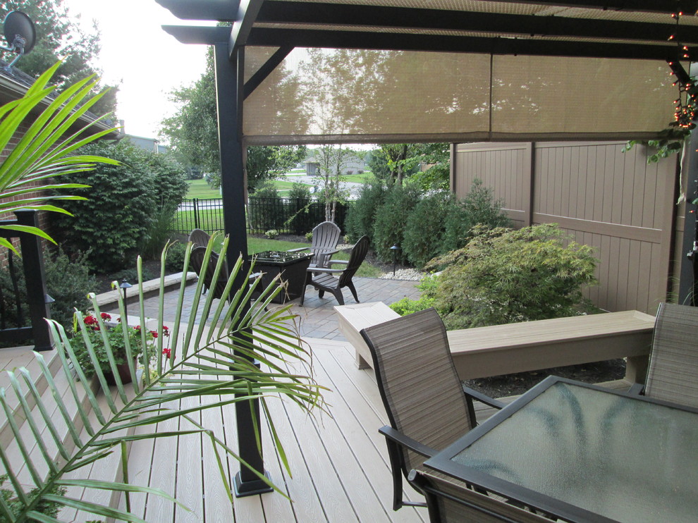 Small transitional backyard deck photo
