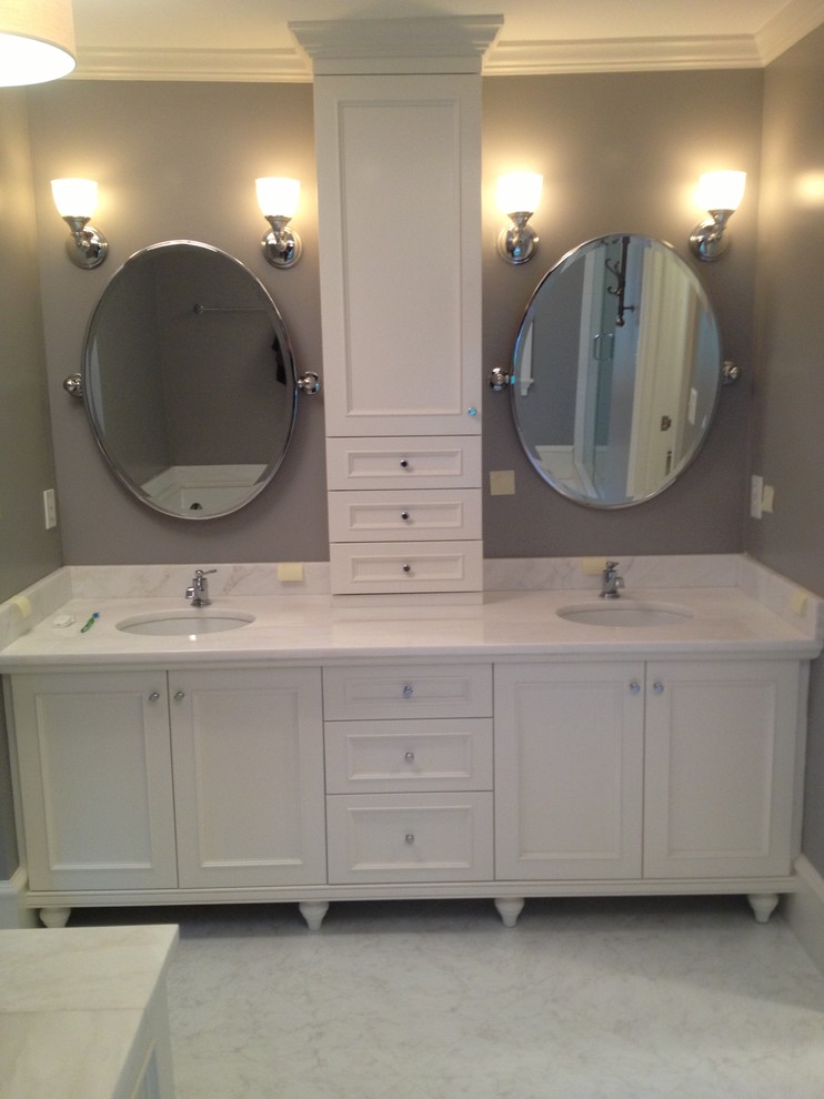 Example of a large transitional master multicolored tile and mosaic tile marble floor drop-in bathtub design in DC Metro with recessed-panel cabinets, white cabinets, a two-piece toilet, gray walls, an undermount sink and marble countertops