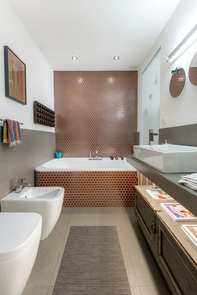 Large contemporary master bathroom in Florence with a drop-in tub, ceramic tile, white walls, porcelain floors, a trough sink and solid surface benchtops.