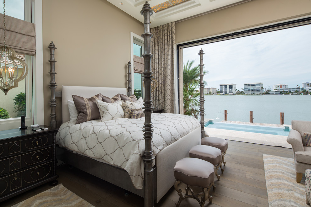 Photo of a mediterranean master bedroom in Miami with beige walls, brown floor and dark hardwood floors.