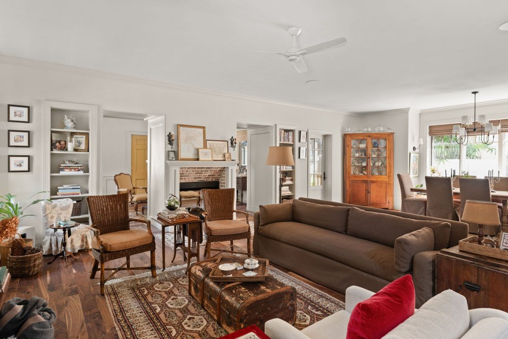 Elegant open concept dark wood floor and brown floor living room photo in Orlando with white walls