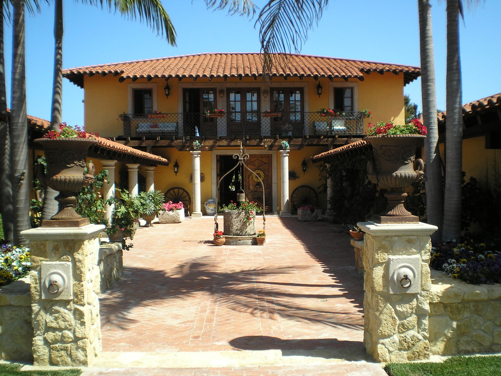 Photo of a large transitional front door in San Diego with yellow walls, a double front door and a medium wood front door.