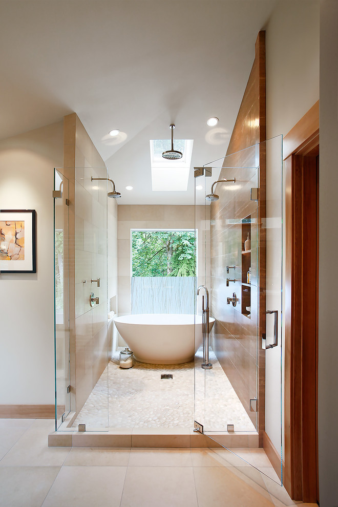 Freestanding bathtub - transitional master beige tile and brown tile pebble tile floor freestanding bathtub idea in Seattle with beige walls and a hinged shower door