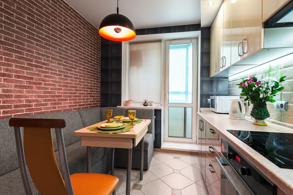 Inspiration for a small contemporary single-wall separate kitchen in Saint Petersburg with an undermount sink, flat-panel cabinets, beige cabinets, laminate benchtops, beige splashback, subway tile splashback, black appliances, ceramic floors, no island and beige floor.