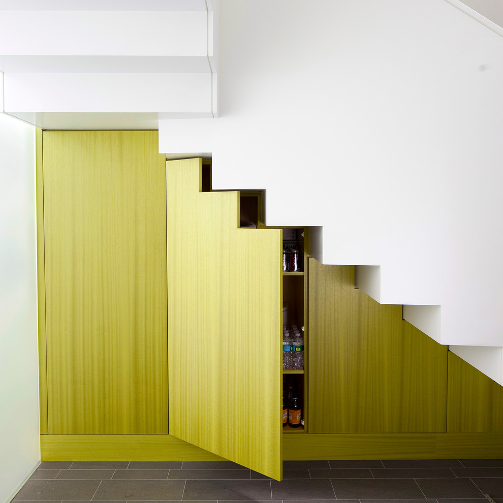 This is an example of a mid-sized contemporary l-shaped staircase in New York.