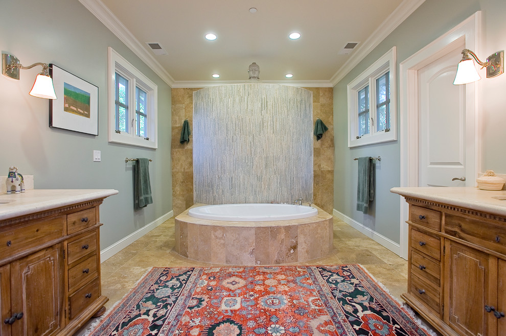 Mid-sized country master bathroom in San Francisco with an undermount sink, furniture-like cabinets, distressed cabinets, limestone benchtops, a drop-in tub, a double shower, a one-piece toilet, brown tile, green walls, travertine floors and stone tile.
