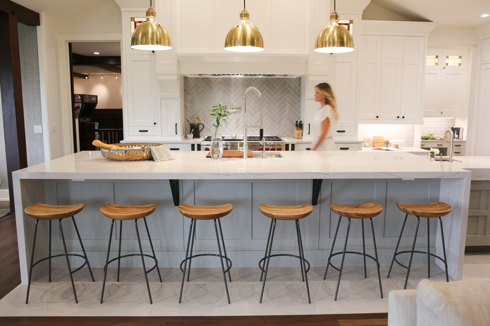 Inspiration for an expansive country galley eat-in kitchen in Vancouver with an undermount sink, shaker cabinets, white cabinets, quartz benchtops, grey splashback, ceramic splashback, stainless steel appliances, ceramic floors, with island, grey floor and white benchtop.
