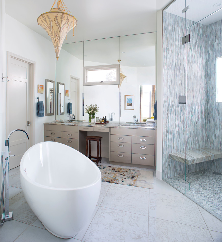 Photo of a mid-sized transitional master bathroom in Denver with flat-panel cabinets, a freestanding tub, gray tile, multi-coloured tile, white walls, porcelain floors, an undermount sink, quartzite benchtops, a hinged shower door, beige cabinets, a curbless shower, beige floor and multi-coloured benchtops.