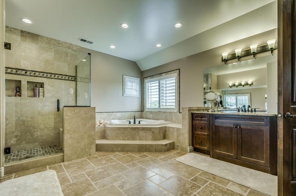 Design ideas for a mid-sized traditional master bathroom in Denver with recessed-panel cabinets, dark wood cabinets, a drop-in tub, an open shower, beige tile, ceramic tile, beige walls, ceramic floors, an undermount sink, granite benchtops, beige floor and a hinged shower door.