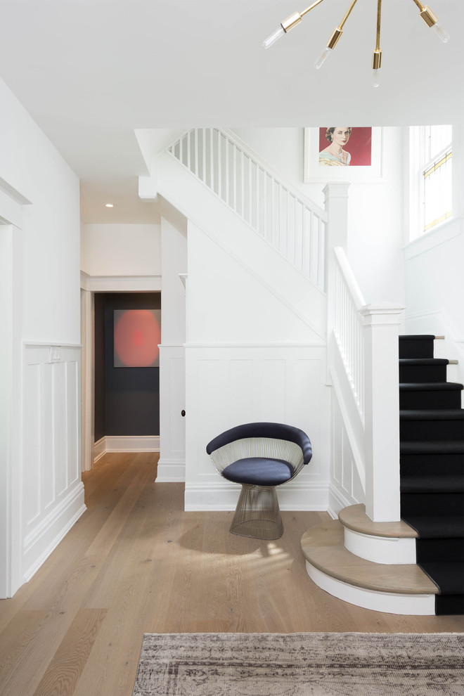 Design ideas for a transitional wood l-shaped staircase in Toronto with painted wood risers.
