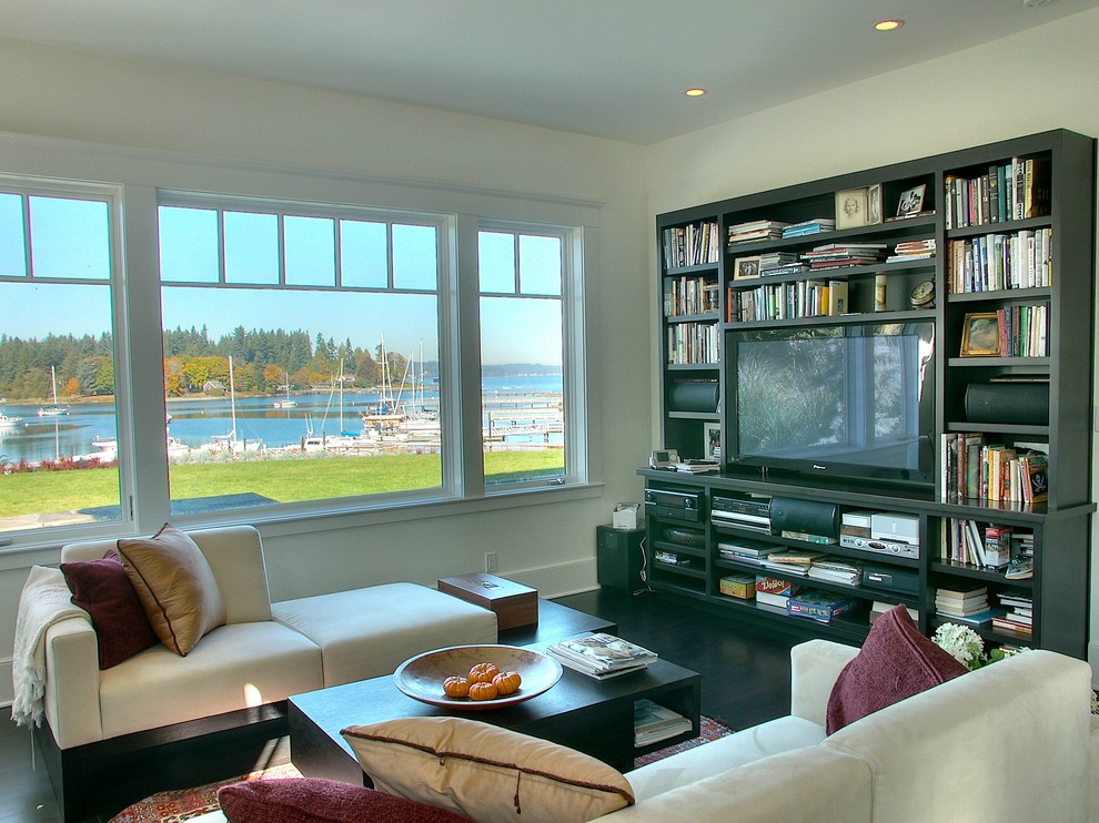 This is an example of a traditional family room in Seattle with white walls.
