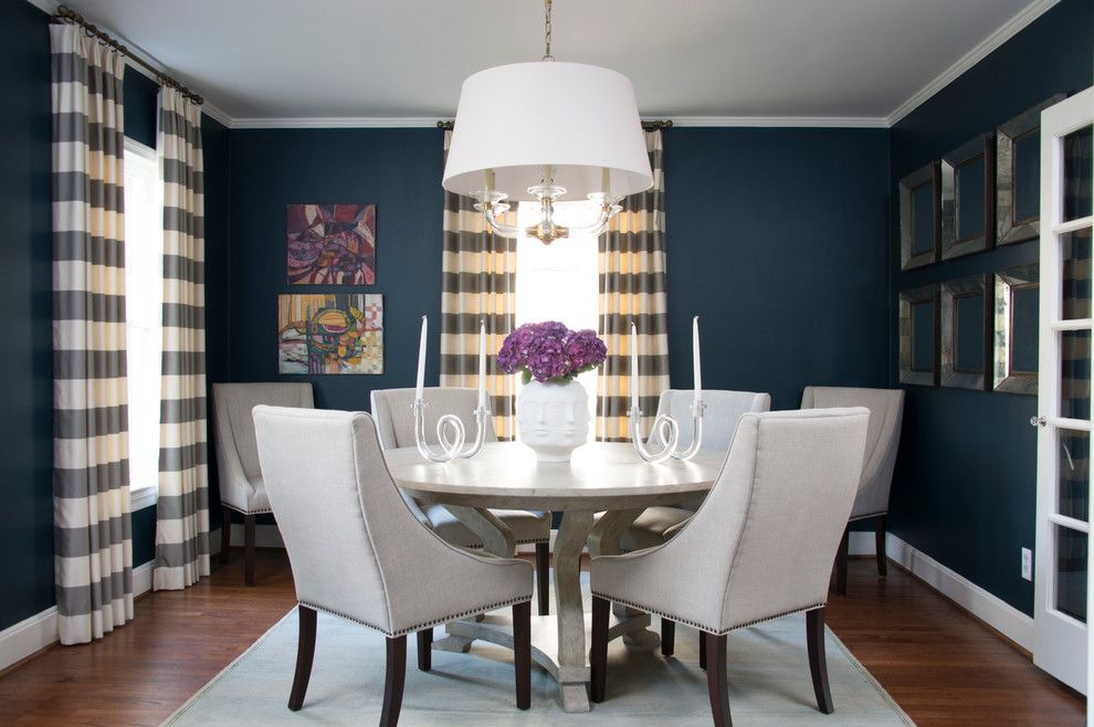 Inspiration for a traditional dining room in Houston with blue walls and medium hardwood floors.