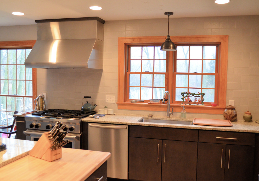 Inspiration for a transitional ceramic tile kitchen remodel with an undermount sink, flat-panel cabinets, gray cabinets, quartz countertops, gray backsplash, ceramic backsplash, stainless steel appliances and an island