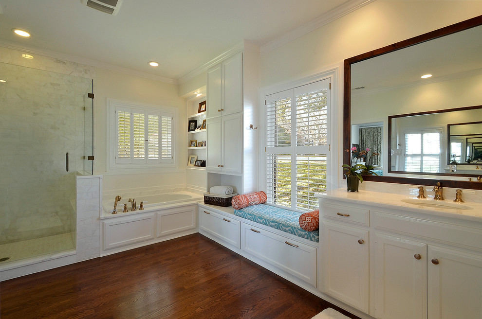 Traditional bathroom in Austin with an undermount sink, recessed-panel cabinets, white cabinets, a drop-in tub, a corner shower and white tile.
