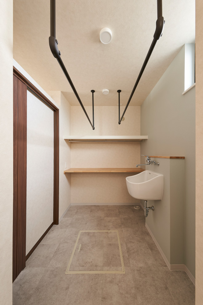 Example of a zen gray floor, wallpaper ceiling and wallpaper laundry room design in Osaka