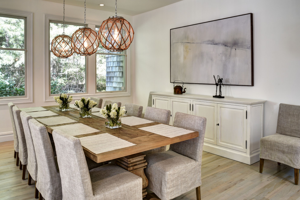 Inspiration for a large transitional dining room in New York with white walls, light hardwood floors and beige floor.