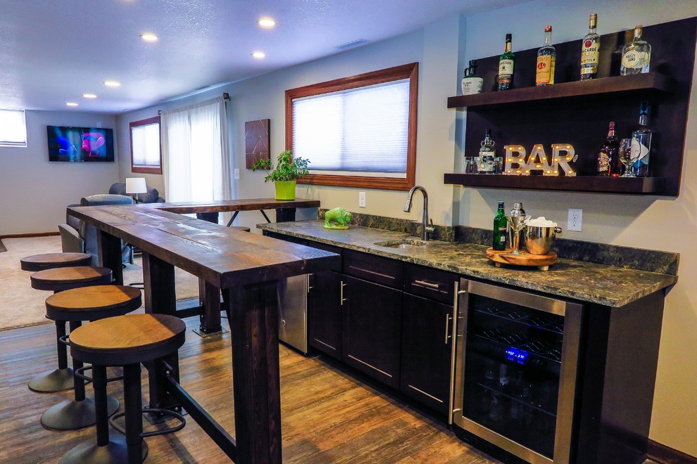 Photo of a mid-sized transitional home bar in Minneapolis with vinyl floors and brown floor.