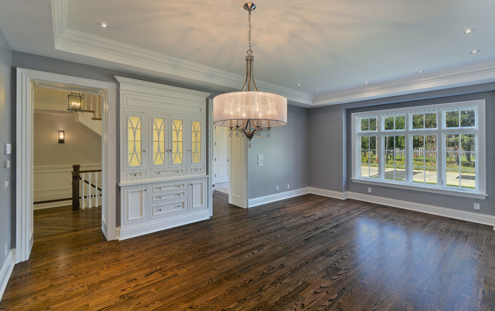 This is an example of a traditional dining room in Toronto with medium hardwood floors.