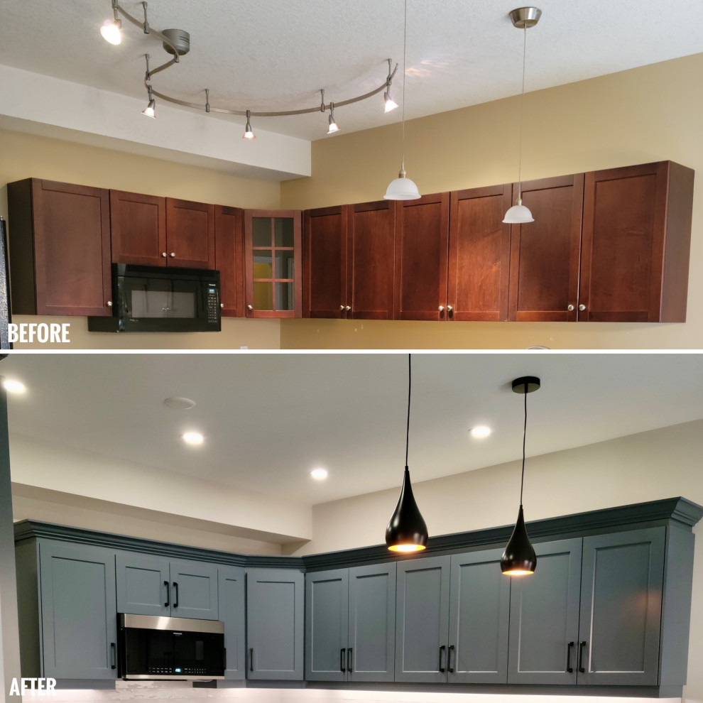 Mid-sized transitional u-shaped vinyl floor eat-in kitchen photo with an undermount sink, recessed-panel cabinets, blue cabinets, quartzite countertops, white backsplash, porcelain backsplash, black appliances, a peninsula and black countertops