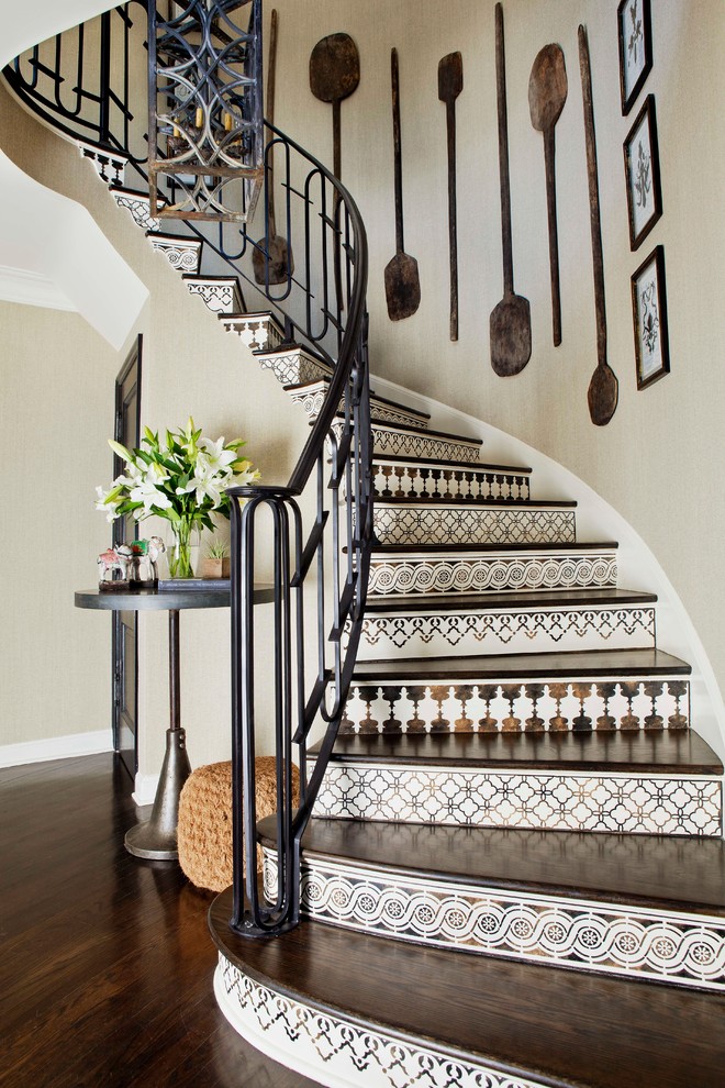 Photo of a mediterranean curved staircase in Los Angeles with tile risers.