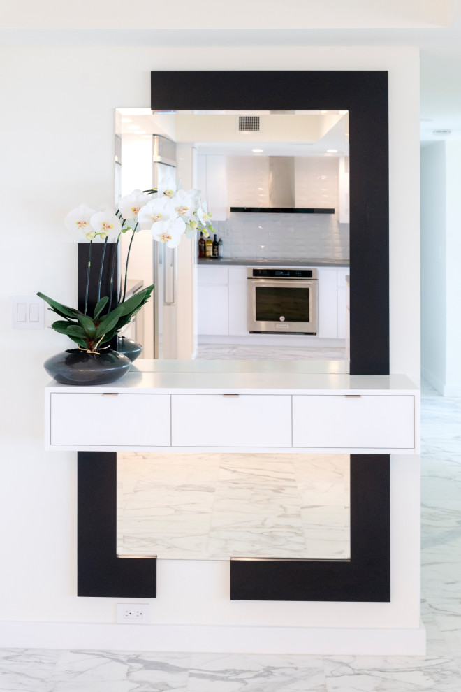 Modern entryway in Miami with white walls, marble floors and white floor.