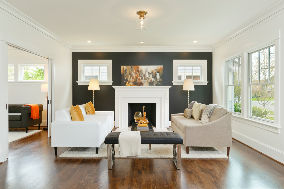Traditional living room in Portland with black walls, dark hardwood floors and a standard fireplace.