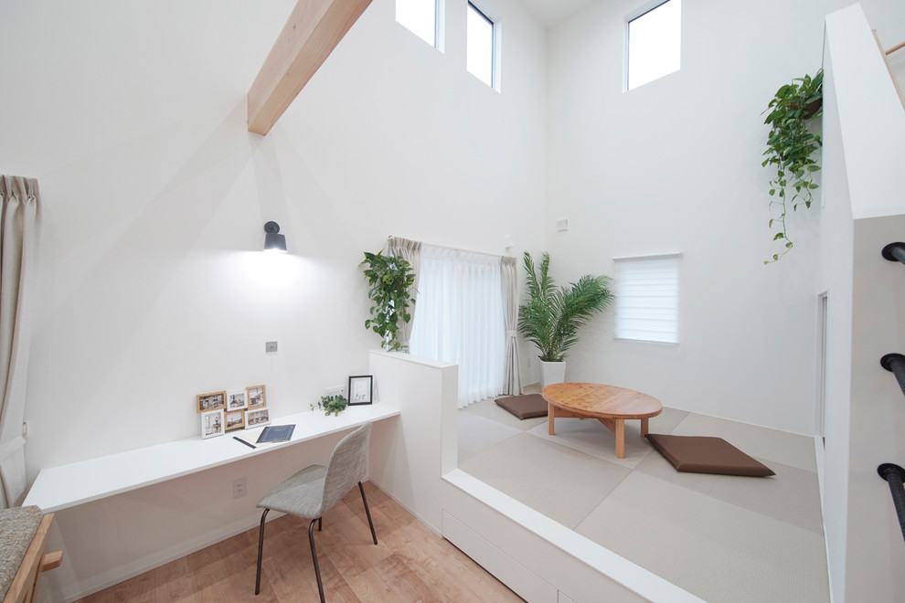 Photo of a scandinavian home office in Other with white walls, tatami floors and grey floor.