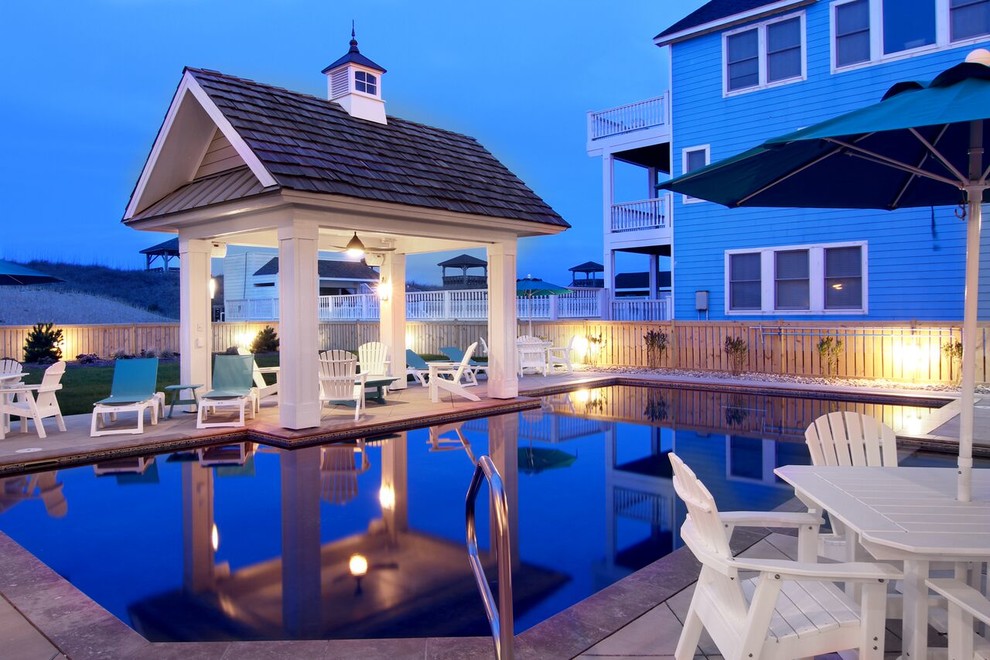 Example of a mid-sized beach style backyard concrete paver and rectangular lap hot tub design