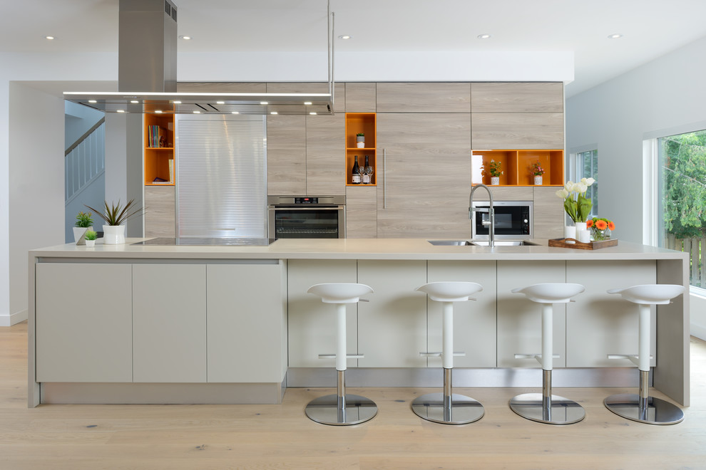 Mid-sized contemporary single-wall eat-in kitchen in Toronto with a double-bowl sink, light hardwood floors, with island, beige floor, flat-panel cabinets, light wood cabinets, quartzite benchtops and panelled appliances.