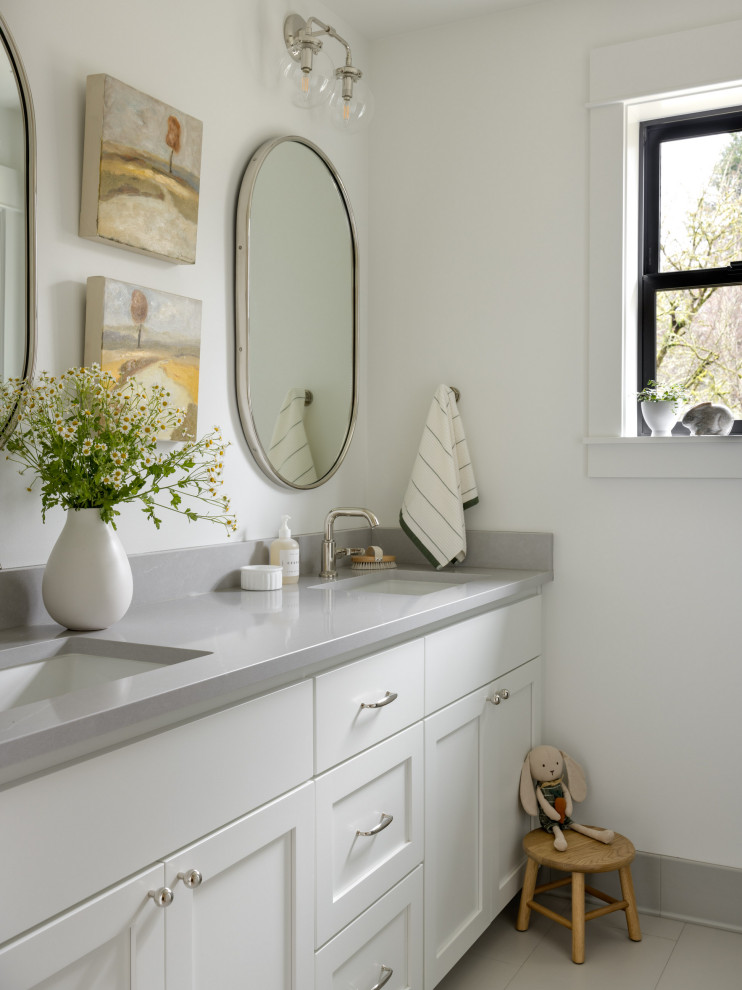 Inspiration for a mid-sized transitional kids' white tile and ceramic tile porcelain tile, gray floor and double-sink alcove bathtub remodel in Seattle with shaker cabinets, white cabinets, a one-piece toilet, white walls, an undermount sink, quartz countertops, gray countertops, a niche and a built-in vanity