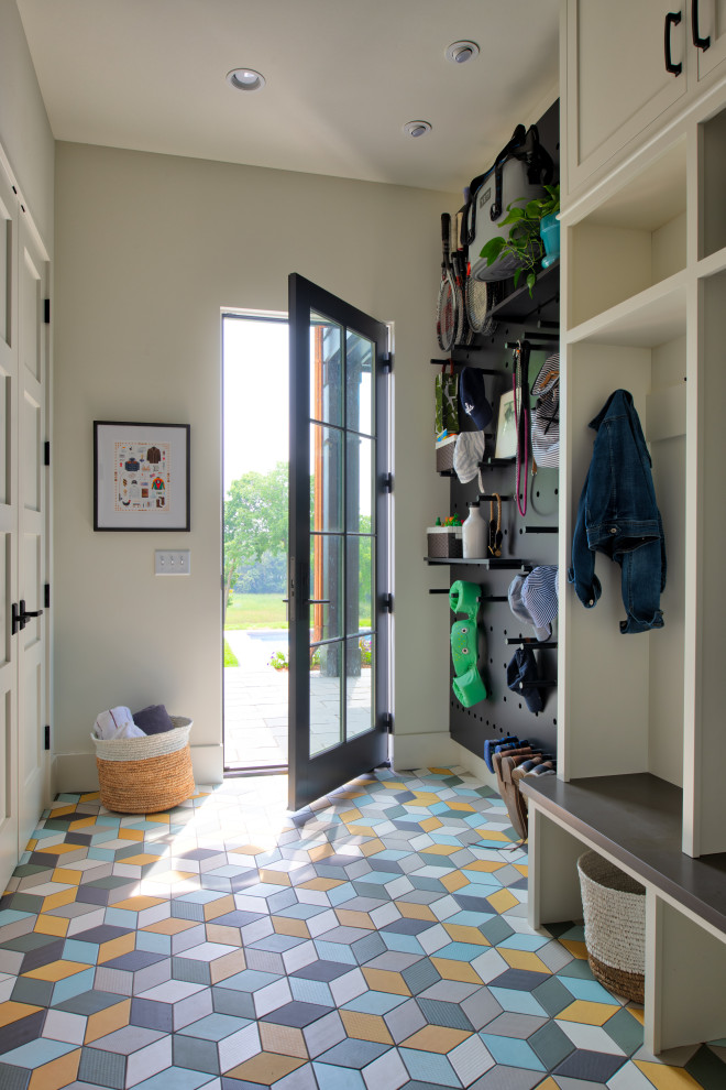 Mid-sized transitional mudroom in Minneapolis with beige walls, a single front door, a black front door and multi-coloured floor.