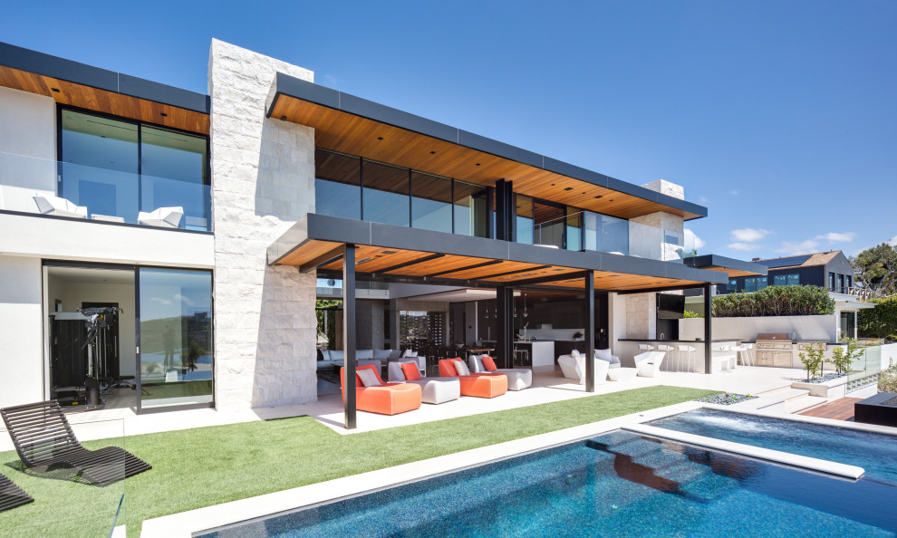 Design ideas for a contemporary backyard pool in Orange County.