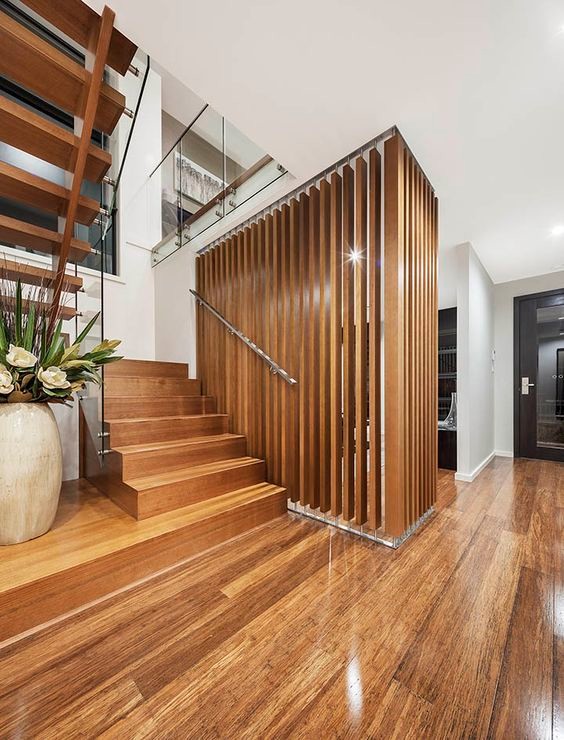 This is an example of a mid-sized modern wood floating staircase in Sydney with open risers.