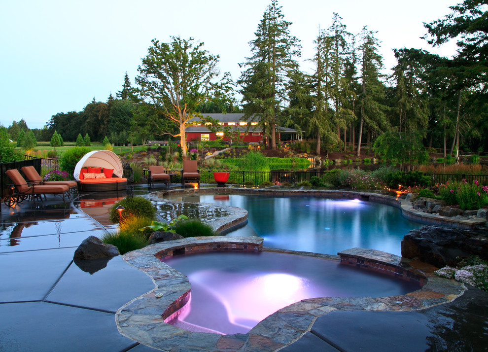 This is an example of a mid-sized arts and crafts natural pool in Portland.