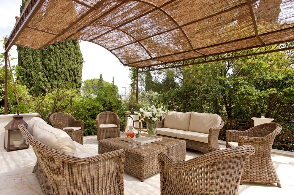 Mid-sized mediterranean backyard patio in Marseille with a pergola.