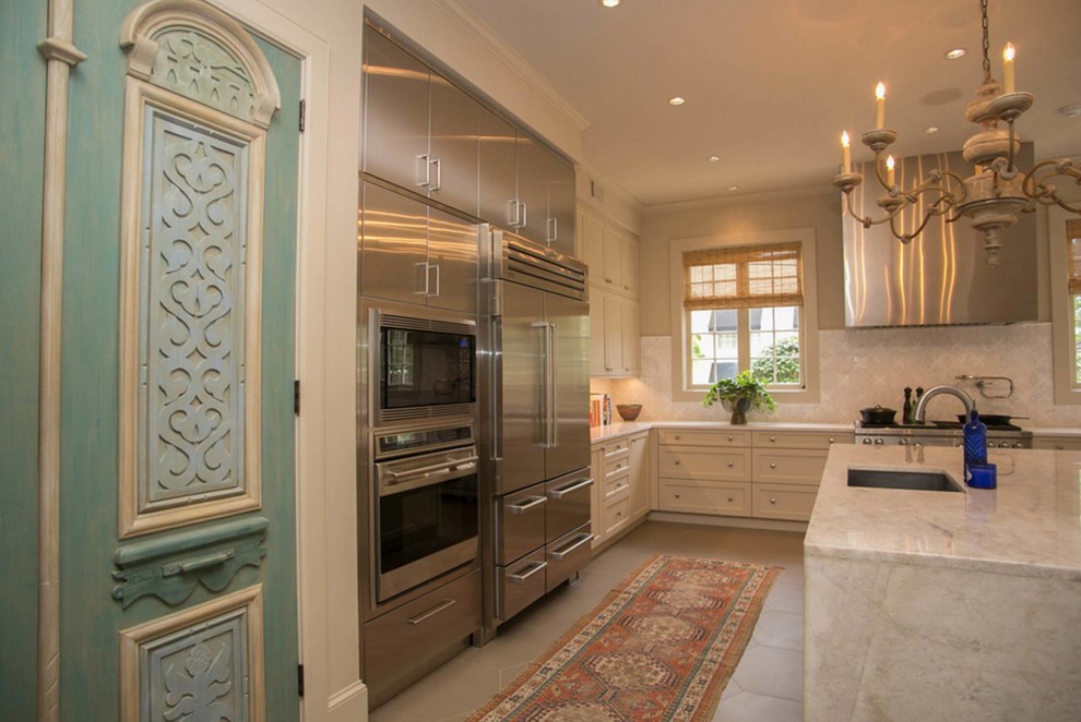 Inspiration for a large transitional u-shaped concrete floor eat-in kitchen remodel in Houston with recessed-panel cabinets, an island, beige cabinets, marble countertops, multicolored backsplash, stone slab backsplash, an undermount sink and stainless steel appliances