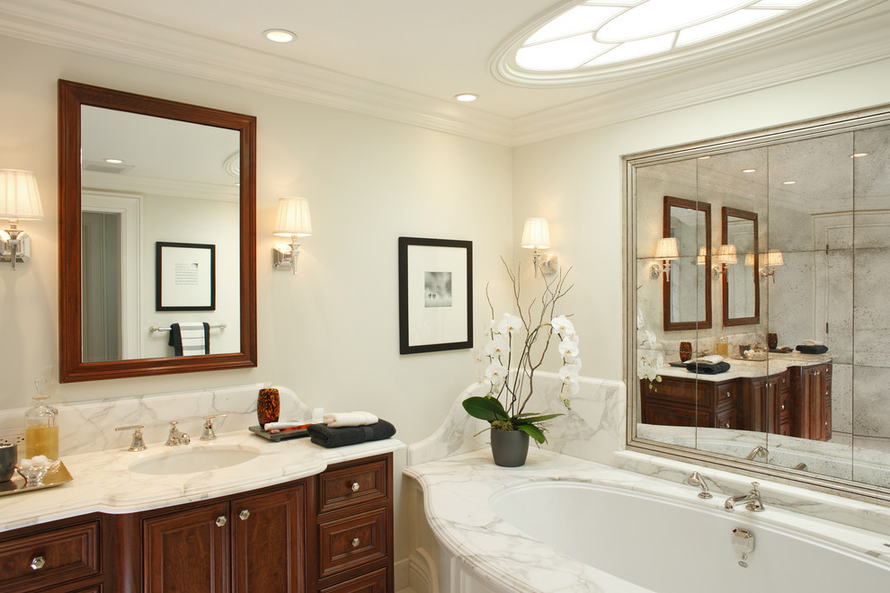 Inspiration for a large contemporary master bathroom in San Francisco with an undermount sink, raised-panel cabinets, dark wood cabinets, an undermount tub, multi-coloured tile, white walls, marble benchtops and marble.