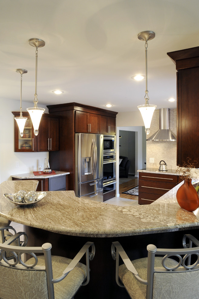 Eat-in kitchen - large transitional u-shaped ceramic tile and beige floor eat-in kitchen idea with a double-bowl sink, shaker cabinets, dark wood cabinets, granite countertops, beige backsplash, mosaic tile backsplash, stainless steel appliances and a peninsula