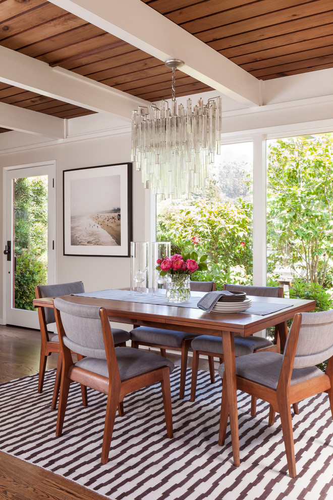 Photo of a large midcentury open plan dining in San Francisco with white walls and dark hardwood floors.