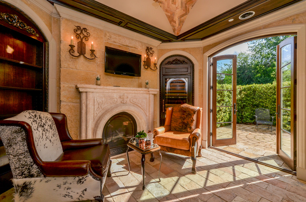 This is an example of a small mediterranean formal enclosed living room in Houston with beige walls, a standard fireplace, a concrete fireplace surround and a wall-mounted tv.